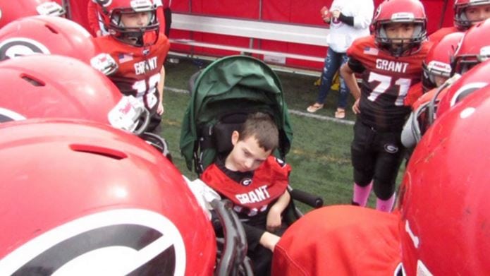 A compassionate high school football team makes 7-year-old with cerebral palsy team captain for the day