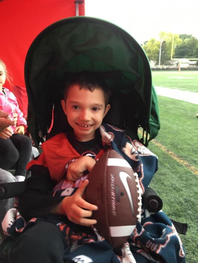 A compassionate high school football team makes 7-year-old with cerebral palsy team captain for the day. 