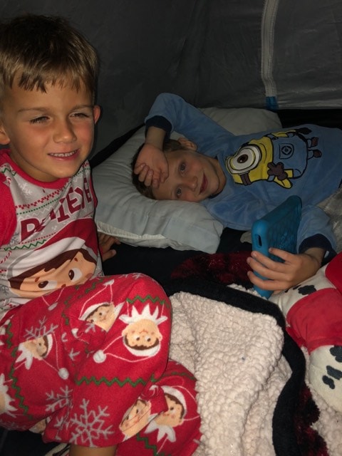 Michael (left) and his friend Jaxson (right) camping out in a tent together. 