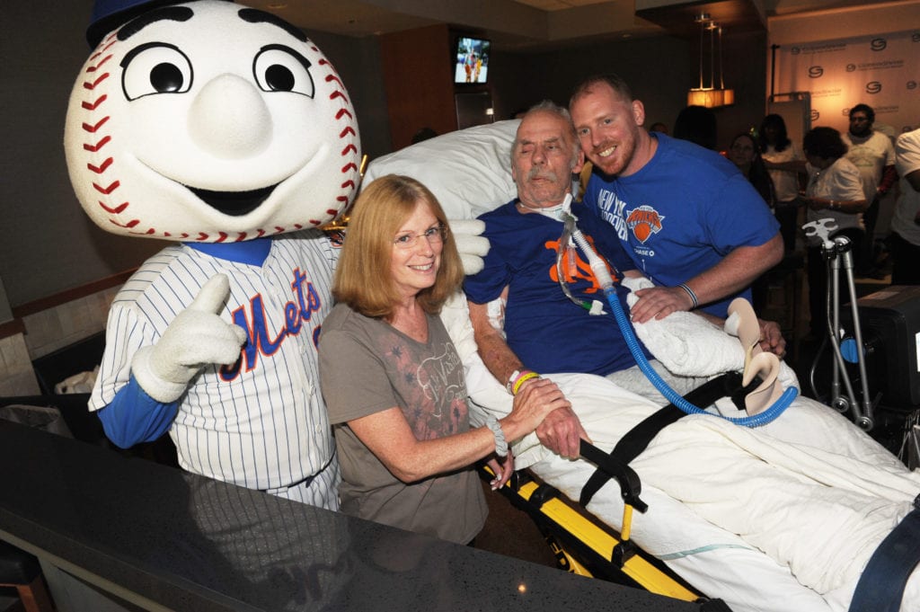 Nursing home patients who haven’t left the facility in 3 years, attend baseball game.  McDermott family and Mr Met.
