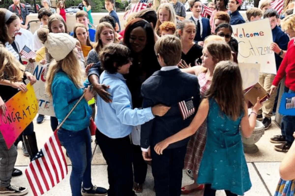 Hardworking teacher celebrates with her students after taking the oath to become a U.S. citizen.