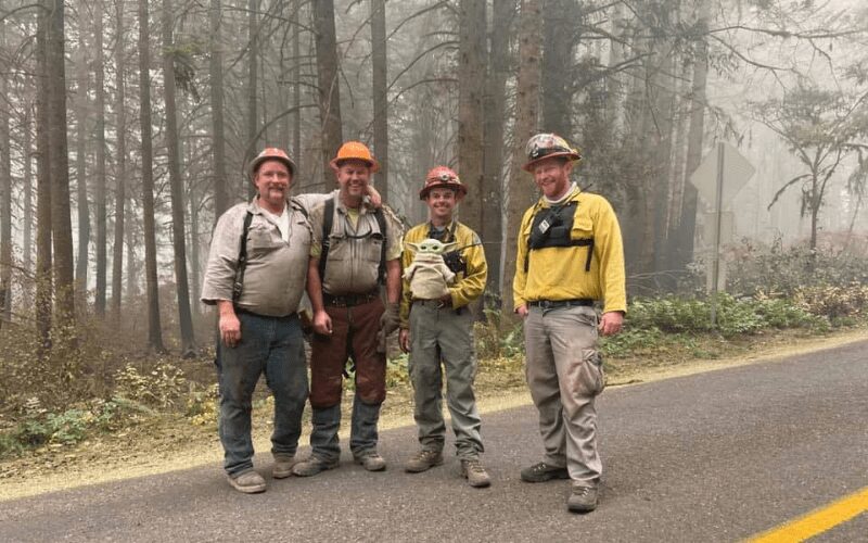 Oregon firefighters holding Baby Yoda.
