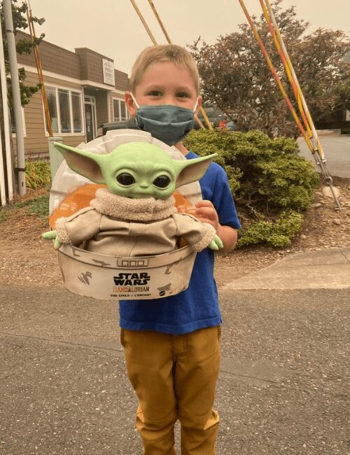 Carver holding Baby Yoda.