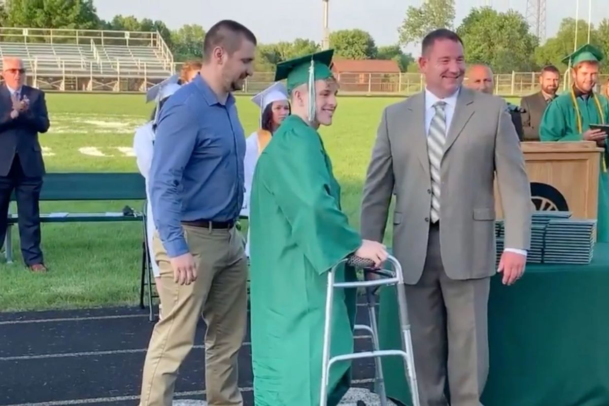 High school senior paralyzed during football game gets standing ovation as he walks at graduation