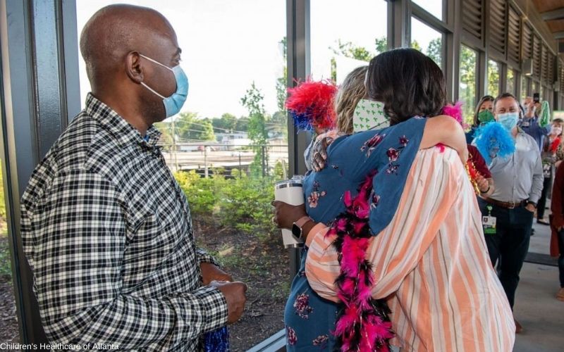 Susan Ellis (right) hugs Tia Wimbush at their welcome back surprise at Children's Healthcare of Atlanta.