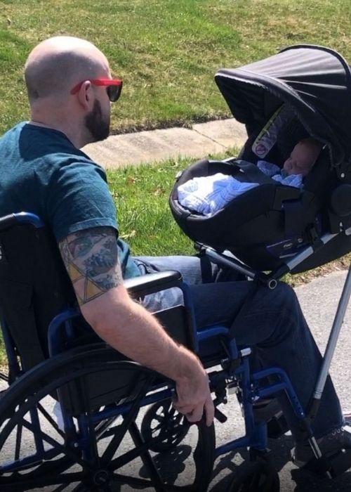 Jeremy King trying out the wheelchair-stroller with his new son Phoenix.