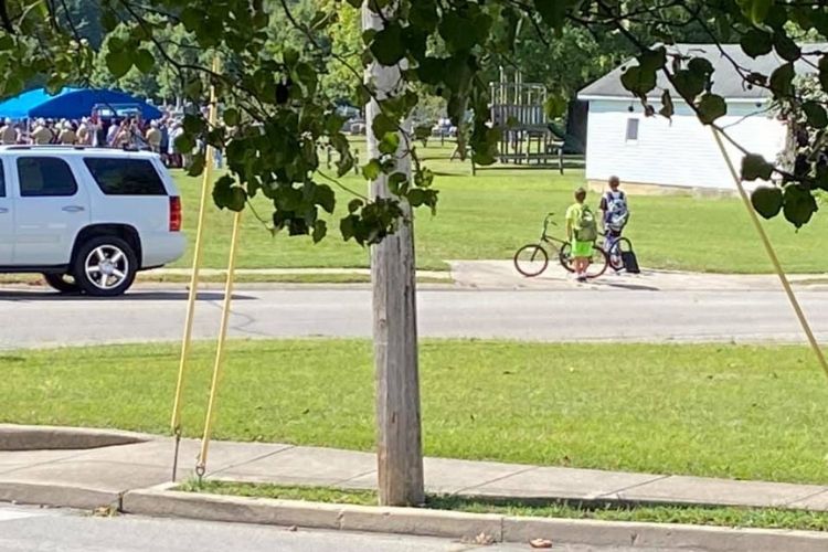 Indiana boys immediately jump off bikes to honor military veteran after seeing his funeral service