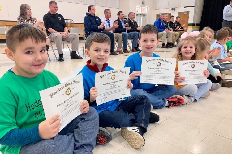 Alabama first graders recognized with special ceremony for saving their teacher's life. 